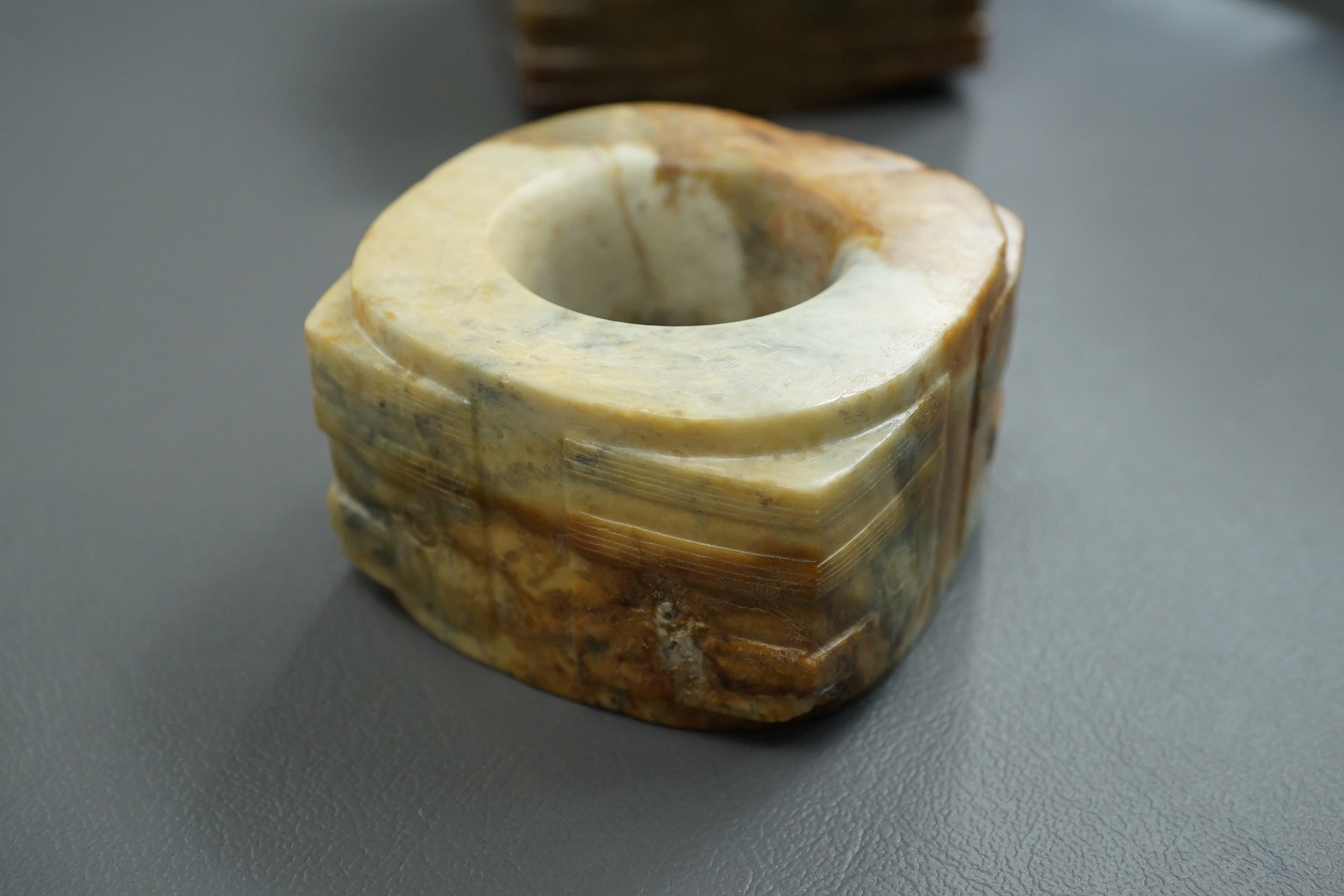 Four Chinese archaistic hardstone or burnt jade cong or cylinders